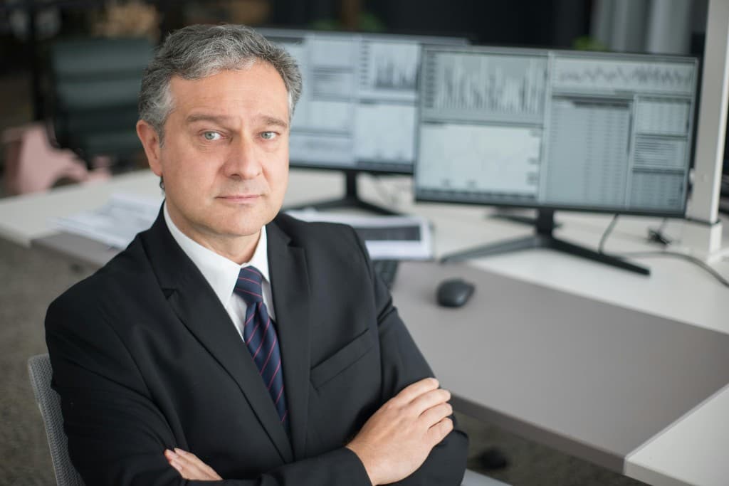 Treasury executive reviewing financial dashboards on dual monitors