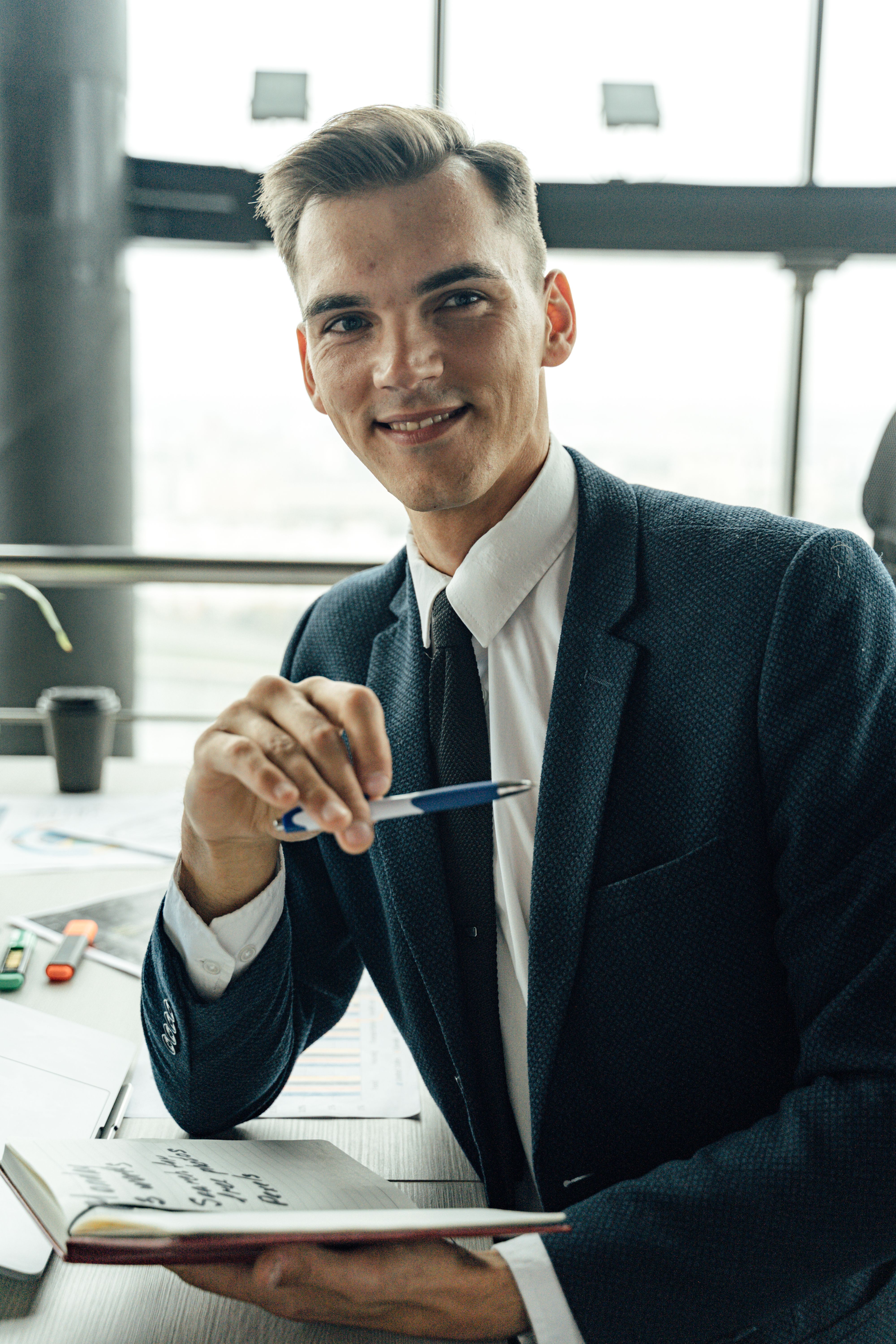 A professional reviewing notes at his desk