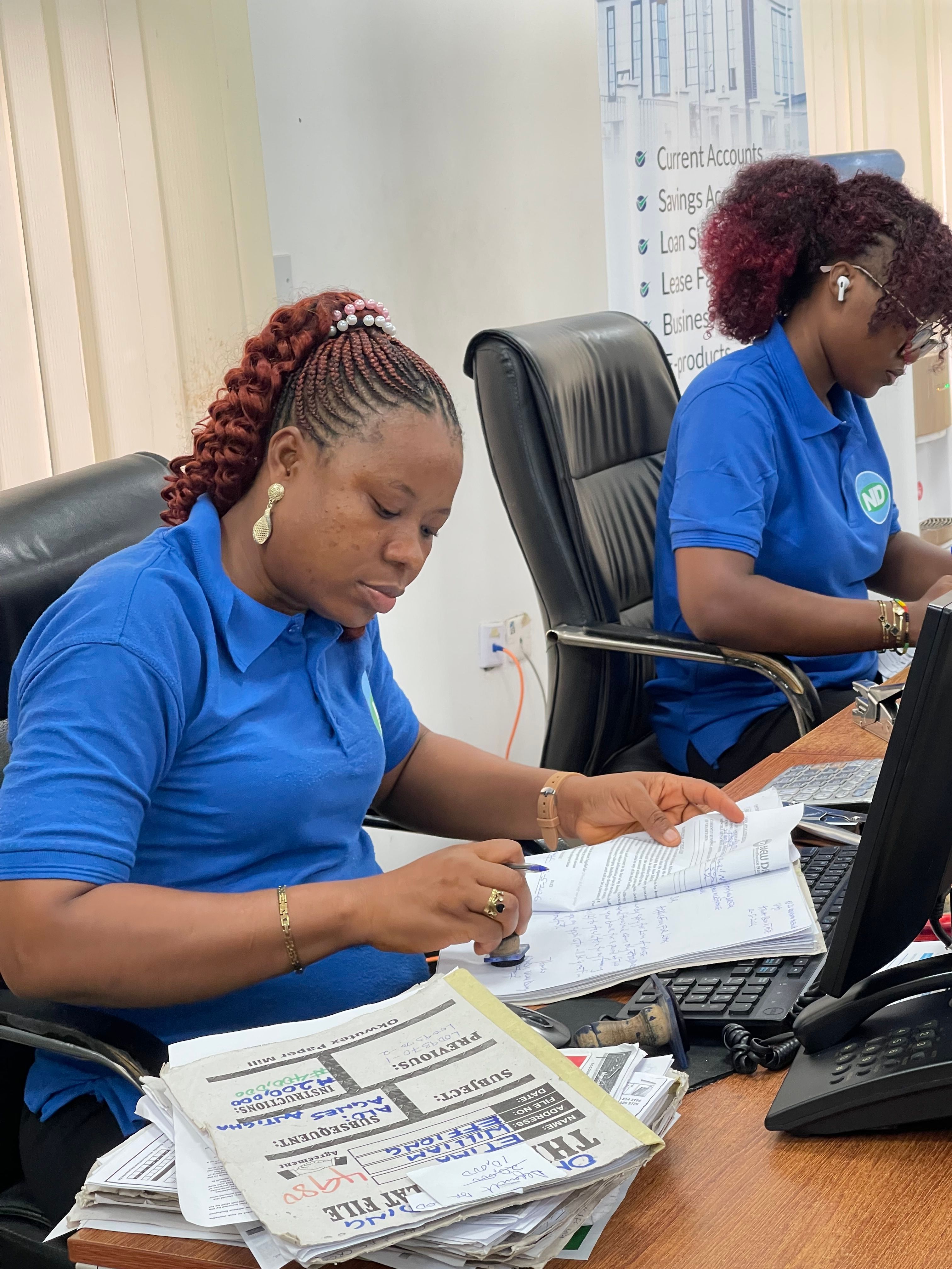 Bookkeepers processing client paperwork at their desks